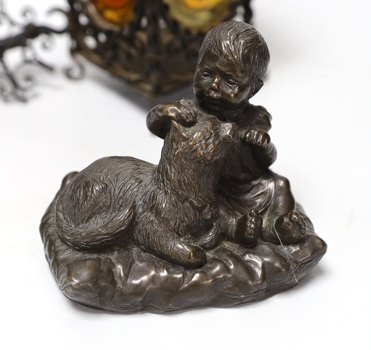 A wrought iron lantern, similar pendant hook, cast miniature brass trunk and bronze effect group, child and dog